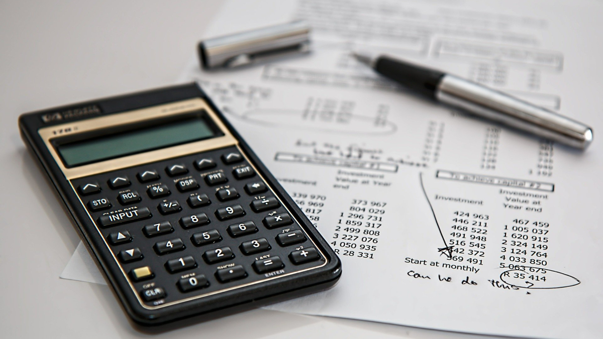 Calculator, financial document and pen